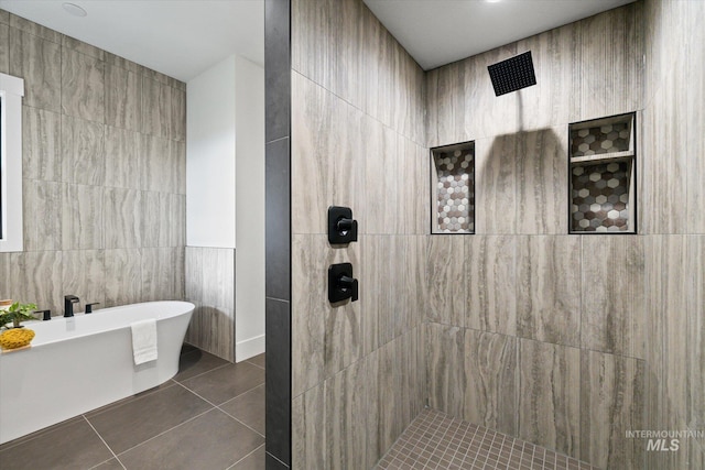 bathroom featuring shower with separate bathtub, tile patterned floors, and tile walls