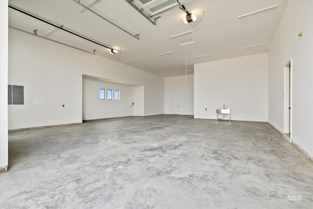 garage with electric panel and a garage door opener