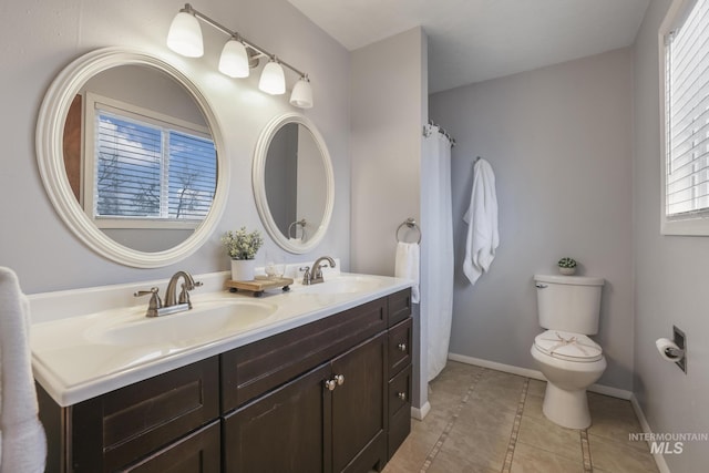 bathroom featuring vanity, tile patterned floors, and toilet