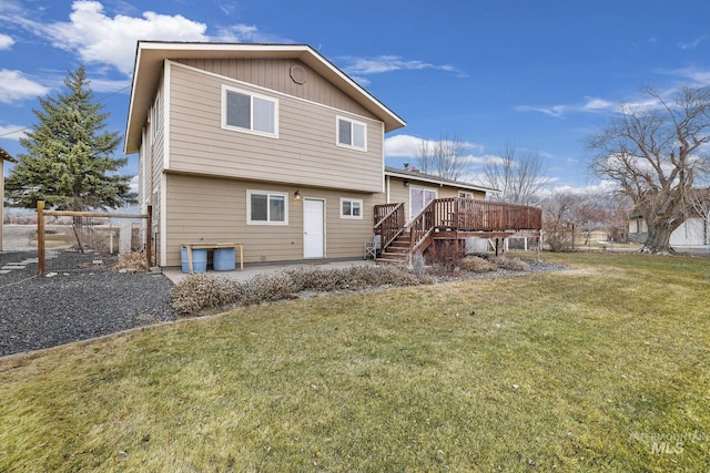 back of house with a wooden deck and a yard