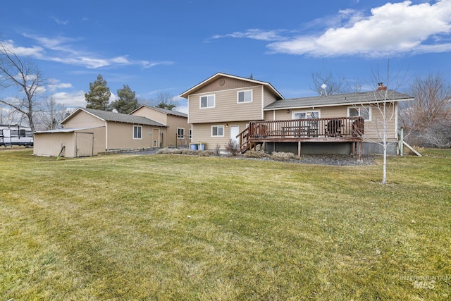 rear view of house with a yard, a deck, and a storage unit