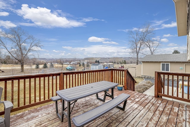 wooden terrace with a storage shed