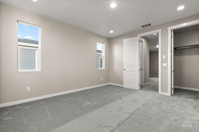 unfurnished bedroom with recessed lighting, baseboards, visible vents, and carpet floors