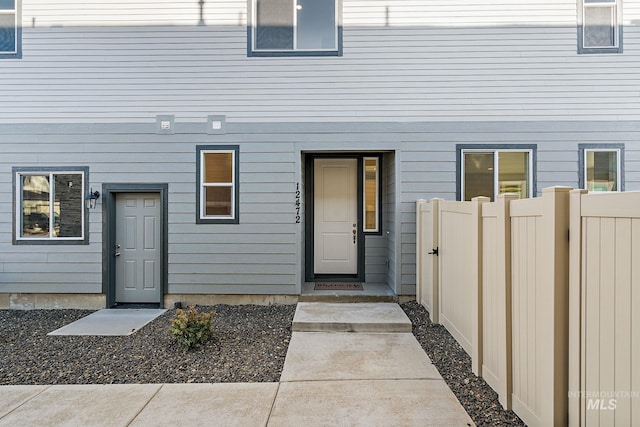 view of exterior entry with fence