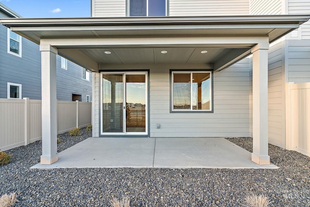 entrance to property with a patio and fence