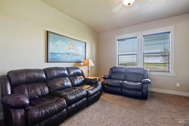 carpeted living room with a textured ceiling and baseboards