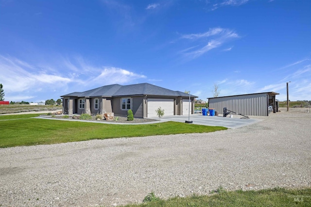 view of front of house featuring a garage, a front lawn, and concrete driveway