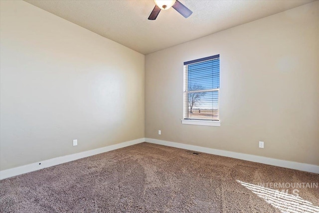 carpeted empty room with ceiling fan and baseboards