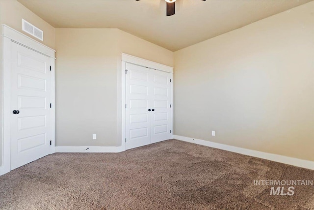 unfurnished bedroom with carpet flooring, visible vents, and baseboards