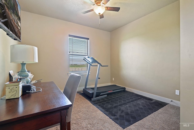 home office with ceiling fan, dark colored carpet, and baseboards