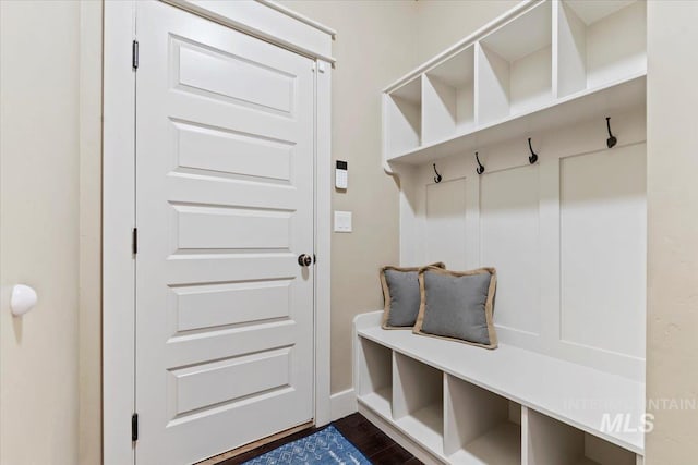 mudroom with dark wood-style floors and baseboards