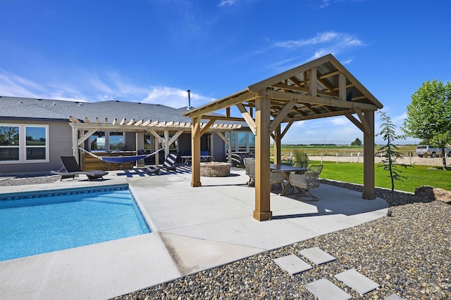 outdoor pool featuring a patio area, an outdoor fire pit, a lawn, and a pergola