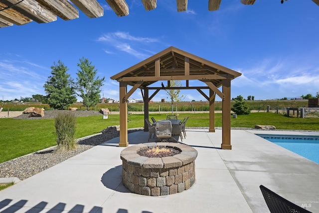 view of patio featuring an outdoor fire pit, an outdoor pool, and a gazebo