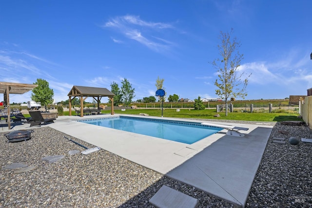 pool featuring fence, a diving board, a lawn, and a gazebo