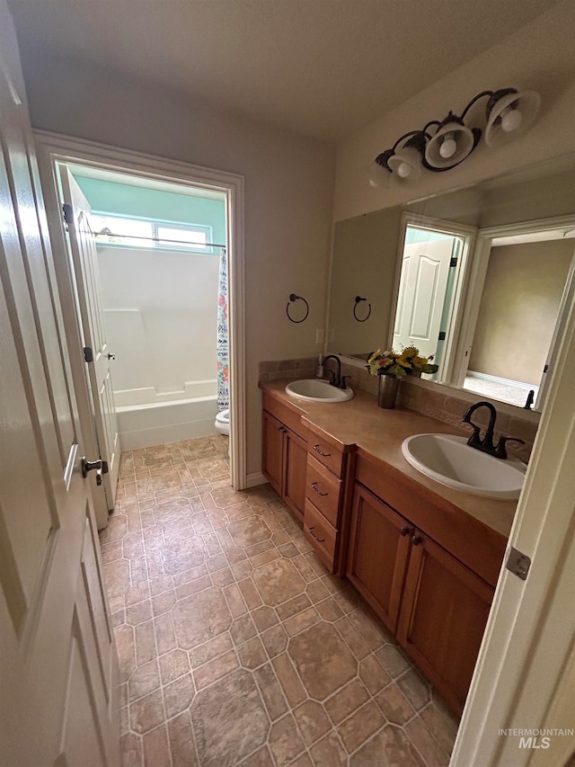 full bathroom with double vanity, tile patterned flooring, toilet, and shower / tub combo with curtain