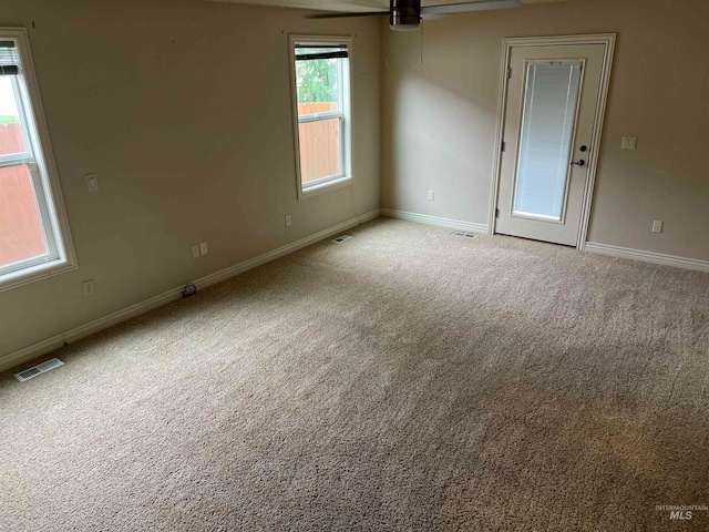 spare room featuring carpet and ceiling fan