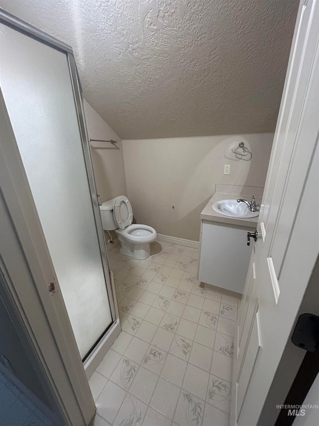 bathroom with a shower with door, a textured ceiling, lofted ceiling, toilet, and vanity