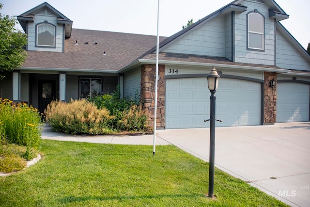 view of front facade with a garage and a front lawn