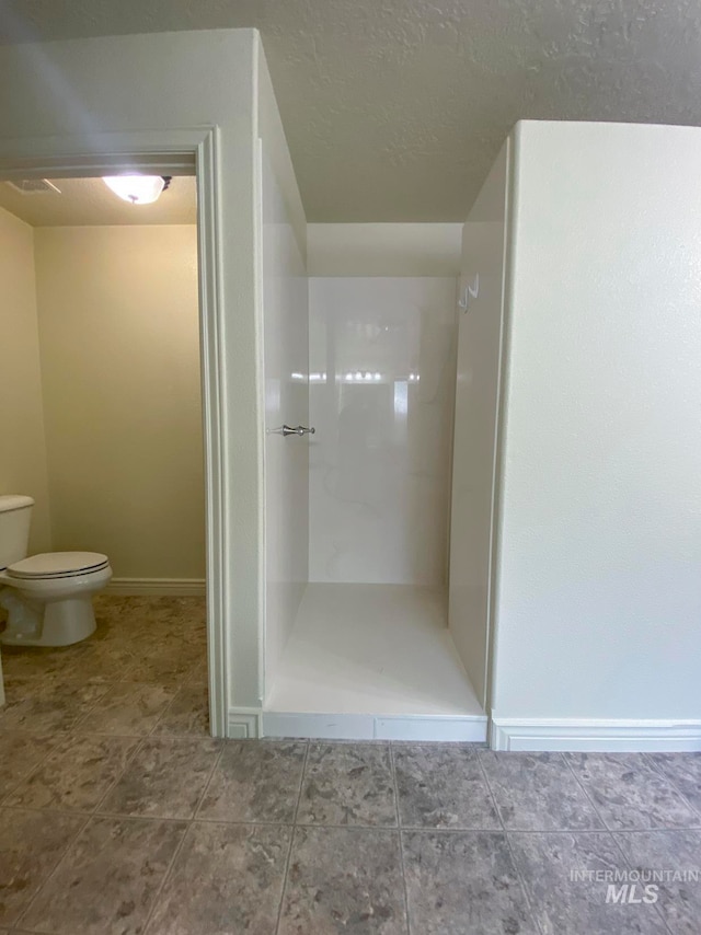 bathroom featuring tile patterned floors and toilet