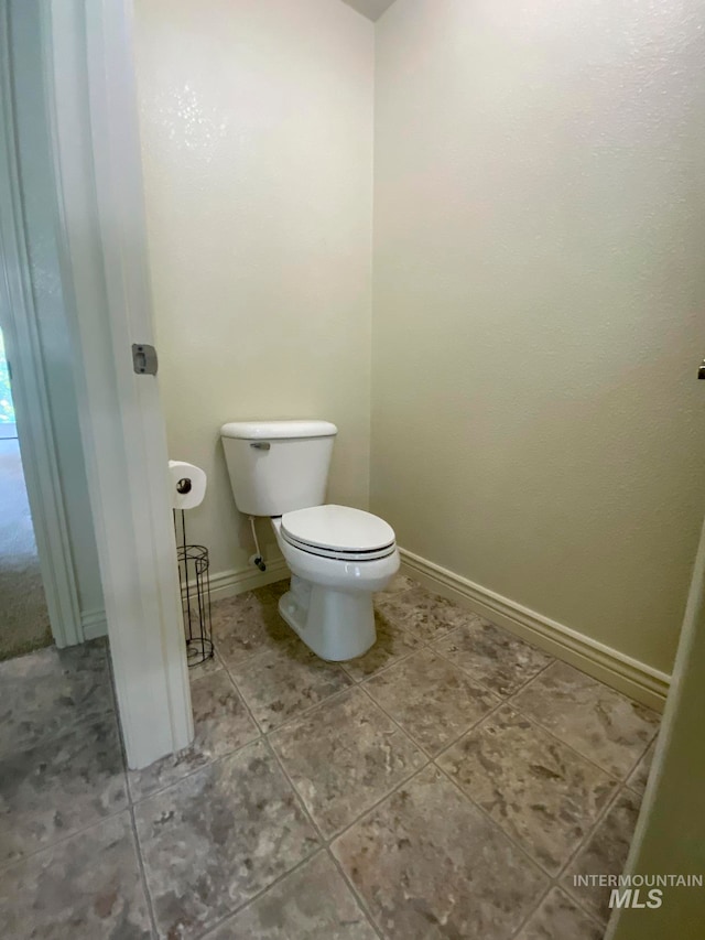 bathroom featuring tile patterned flooring and toilet