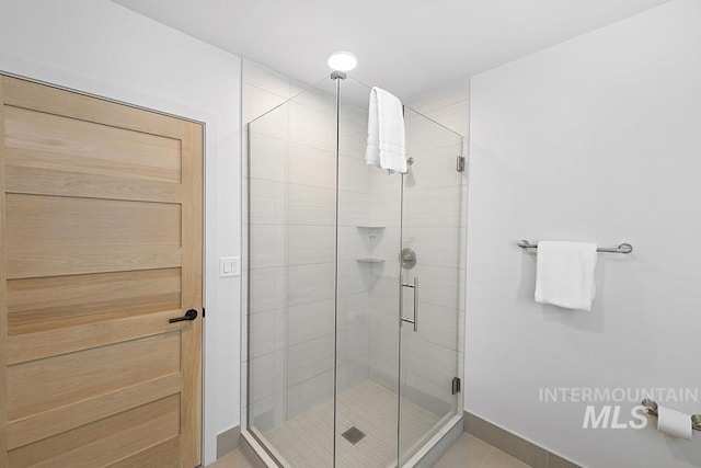 720 Village Dr Unit 404, Donnelly, ID 83615 - full bathroom with a stall shower, tile patterned floors, and baseboards