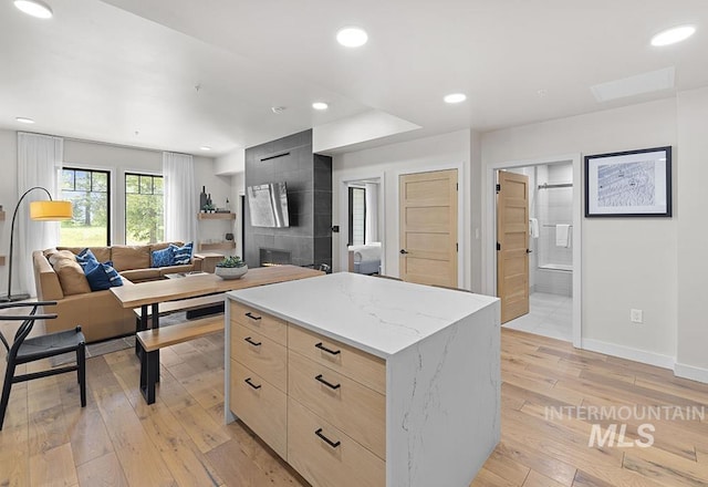 720 Village Dr Unit 404, Donnelly, ID 83615 - kitchen with modern cabinets, light brown cabinets, light wood-style flooring, a kitchen island, and baseboards