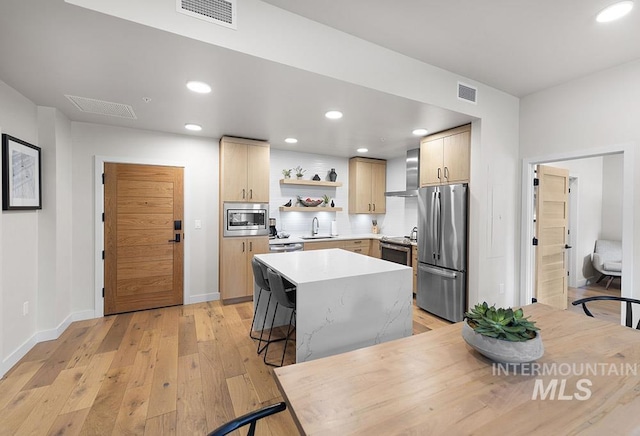 720 Village Dr Unit 404, Donnelly, ID 83615 - kitchen with stainless steel appliances, open shelves, light wood-type flooring, light brown cabinetry, and a sink