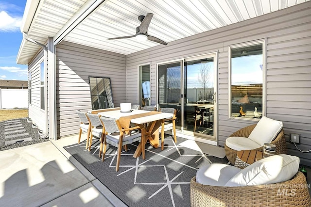 sunroom / solarium featuring ceiling fan, outdoor dining space, and healthy amount of natural light