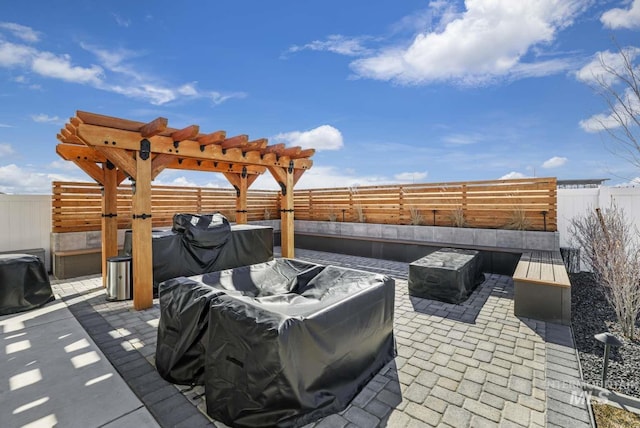 view of patio / terrace with a fenced backyard, a grill, and a pergola