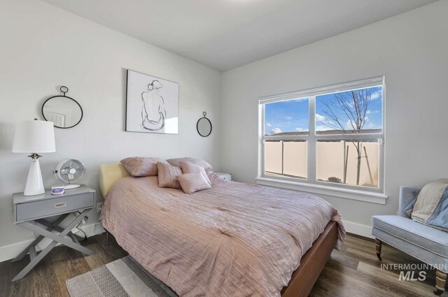 bedroom featuring baseboards and wood finished floors