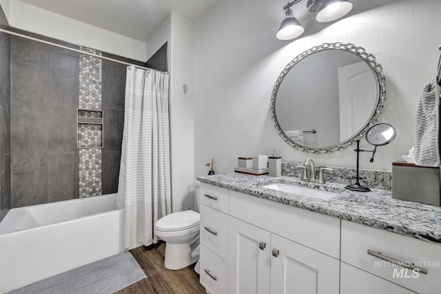 bathroom with wood finished floors, toilet, shower / tub combo with curtain, and vanity