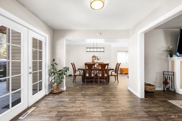 dining room featuring baseboards, visible vents, and dark wood-type flooring