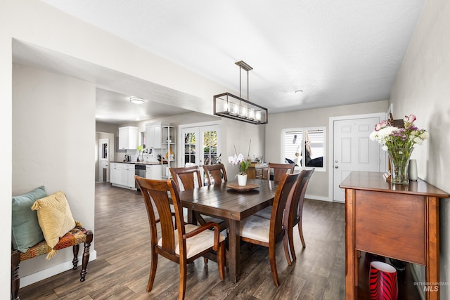 dining area featuring baseboards and dark wood-type flooring