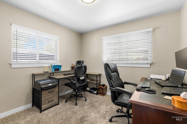 home office featuring baseboards and carpet