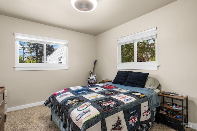 carpeted bedroom featuring baseboards