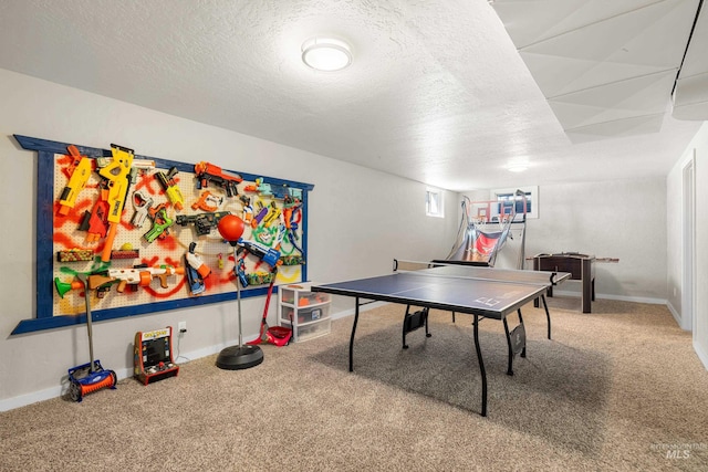 rec room with carpet floors, a textured ceiling, and baseboards