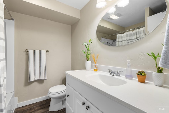 full bathroom featuring toilet, a shower with curtain, wood finished floors, and vanity