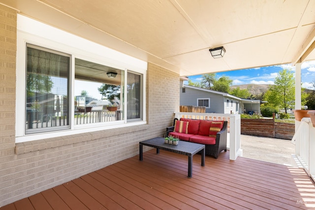 deck with outdoor lounge area and a mountain view