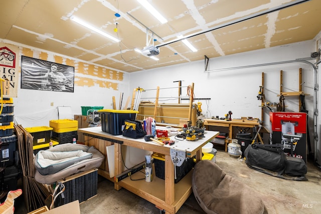 garage with a workshop area and a garage door opener