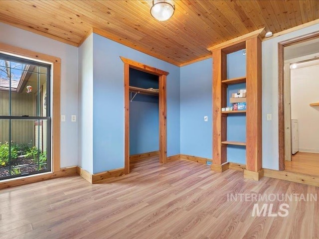 unfurnished bedroom featuring baseboards, wood finished floors, multiple windows, and wooden ceiling