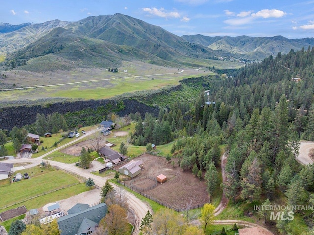 birds eye view of property featuring a mountain view and a wooded view