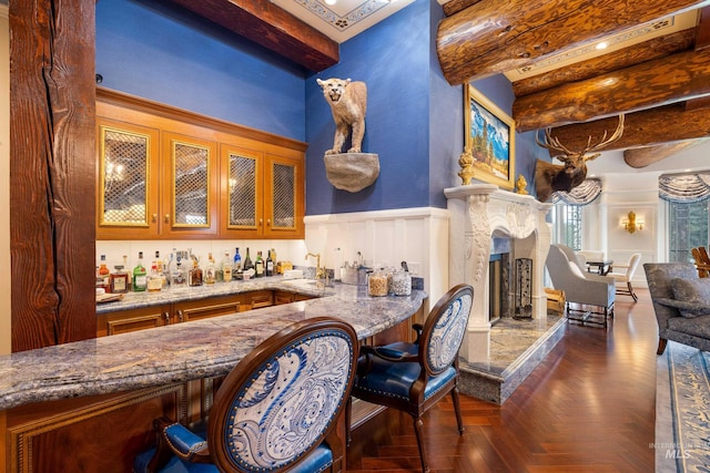 4305 Song Sparrow Ct, Mccall, ID 83638 - indoor wet bar with beamed ceiling, a decorative wall, wainscoting, and a fireplace
