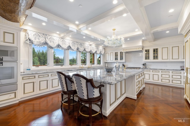 4305 Song Sparrow Ct, Mccall, ID 83638 - kitchen with wall oven, a center island, light stone counters, tasteful backsplash, and a chandelier