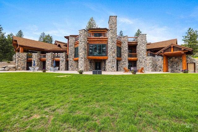 4305 Song Sparrow Ct, Mccall, ID 83638 - back of property featuring stone siding, a yard, a balcony, a patio area, and a chimney