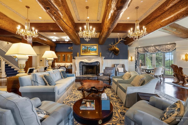 4305 Song Sparrow Ct, Mccall, ID 83638 - living room with a chandelier, beam ceiling, wood finished floors, a high end fireplace, and a decorative wall