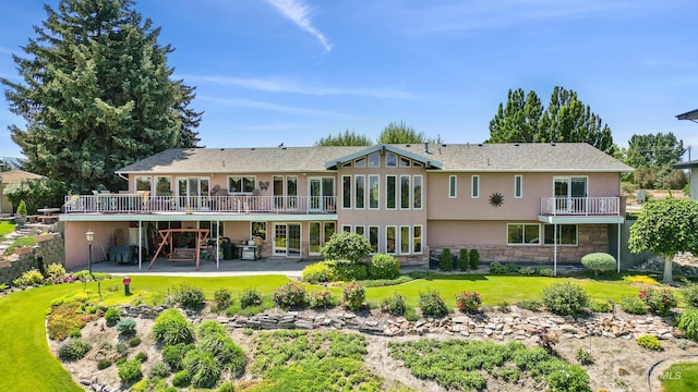 15 Van Engelen Rd, Burley, ID 83318 - rear view of property with stucco siding, stone siding, a patio area, a wooden deck, and a lawn