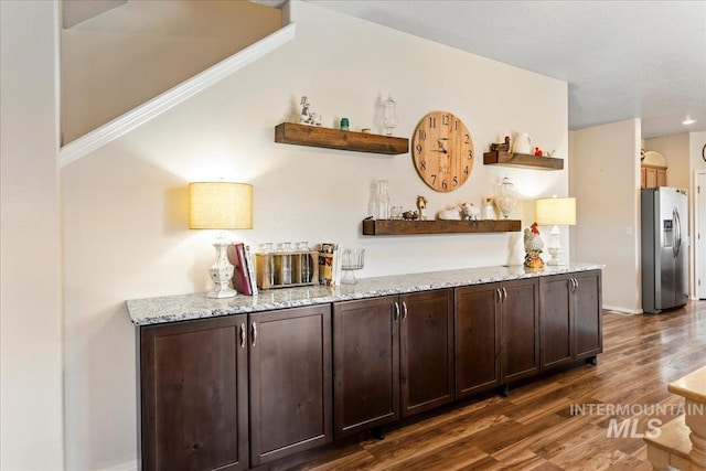 2175 W Willow Pointe Ave, Nampa, ID 83651 - indoor dry bar with stainless steel refrigerator with ice dispenser, dark wood-style floors, and baseboards