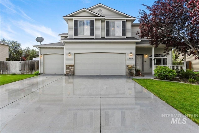 2175 W Willow Pointe Ave, Nampa, ID 83651 - traditional-style house featuring an attached garage, driveway, covered porch, and stone siding