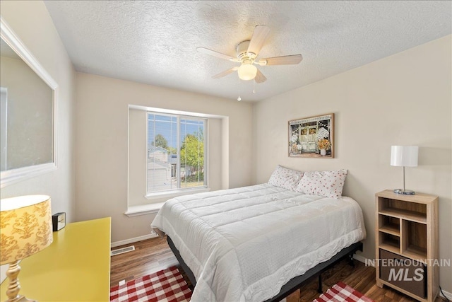 2175 W Willow Pointe Ave, Nampa, ID 83651 - bedroom with wood finished floors, baseboards, a textured ceiling, and ceiling fan