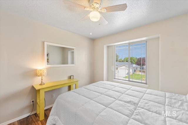 2175 W Willow Pointe Ave, Nampa, ID 83651 - bedroom featuring wood finished floors, a textured ceiling, baseboards, and a ceiling fan
